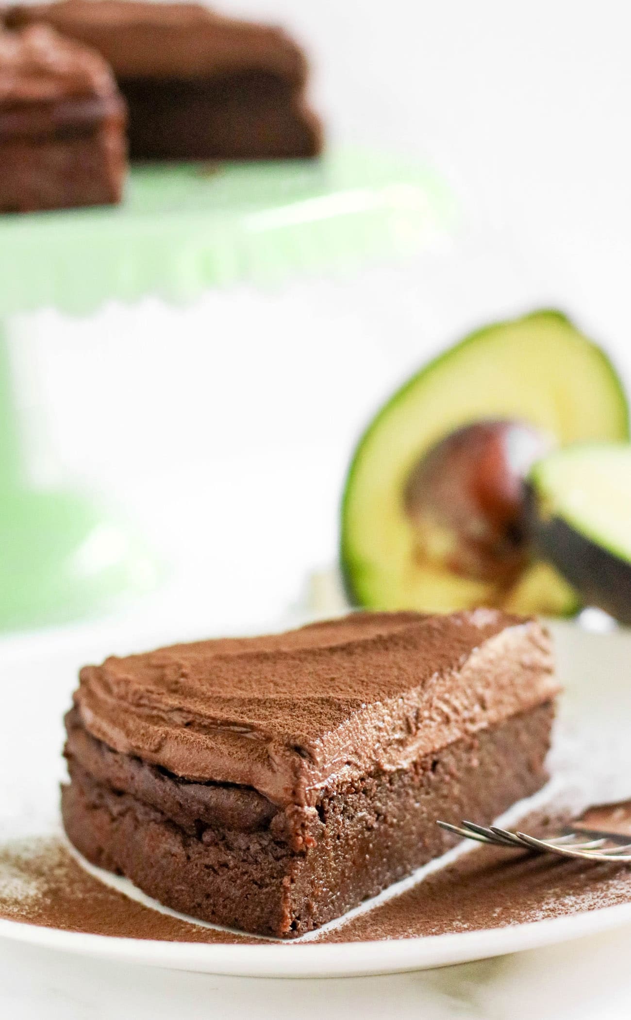 This healthier Chocolate Avocado Cake is super chocolatey, perfectly sweet, and nutritionally balanced with healthy fats, whole grains, lots of fiber, and a hit of protein! It's just as rich, and chocolatey as classic chocolate cake, except this is made without the butter, oil, regular white sugar, and bleached flour!