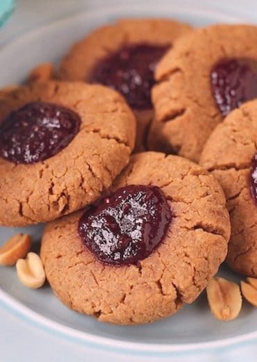 These Healthy Peanut Butter and Jelly Thumbprint Cookies are soft, chewy and delicious. You'd never they're sugar free, high protein, gluten free and vegan! -- Healthy Dessert Recipes at Desserts with Benefits
