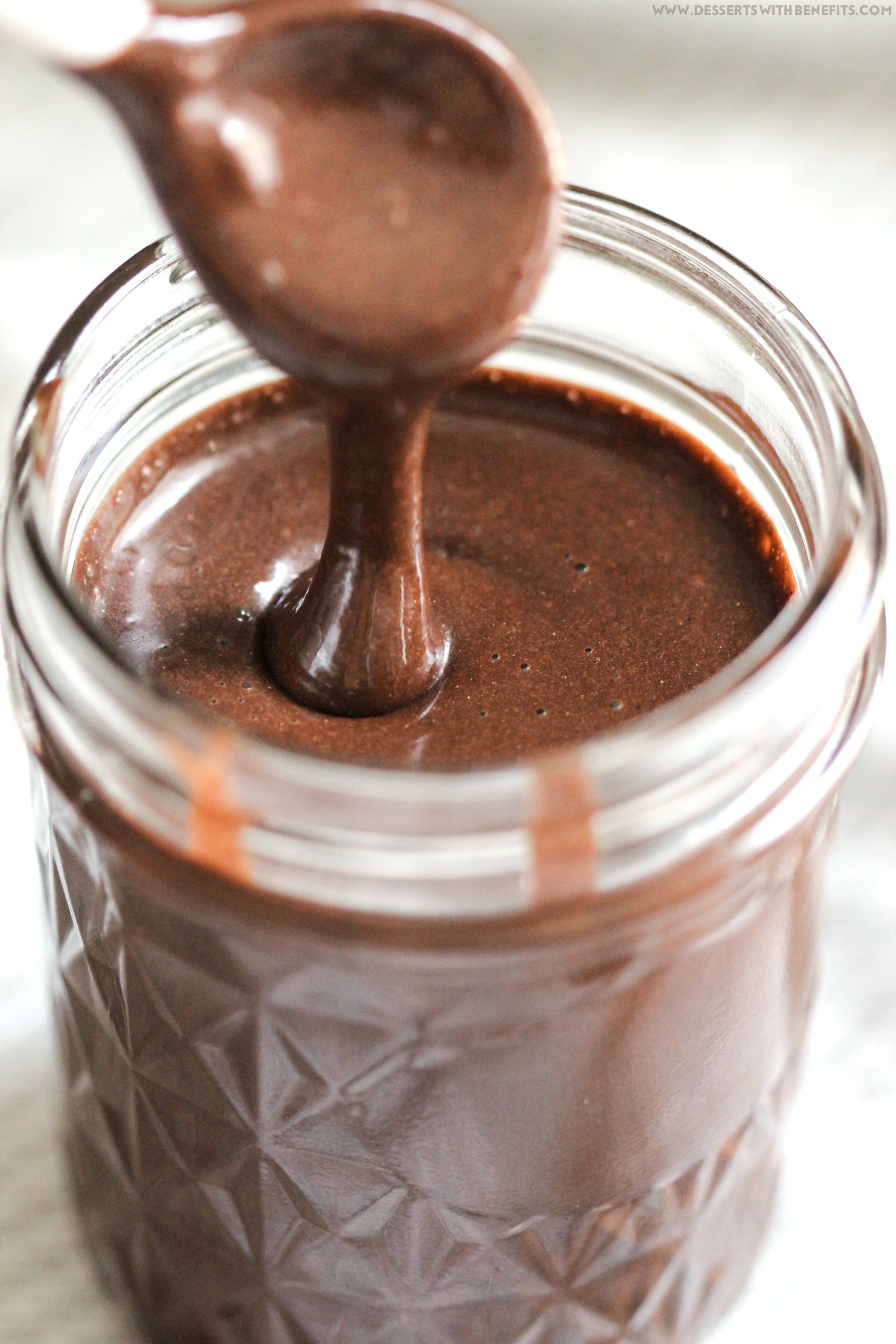 Healthy Homemade Chocolate Syrup recipe -- thick, rich, sweet, and chocolatey, yet secretly sugar free, low fat, high fiber, gluten free, and vegan! Perfect in chocolate milk, milkshakes, smoothies, oatmeal, and more. Healthy Dessert Recipes at Desserts with Benefits