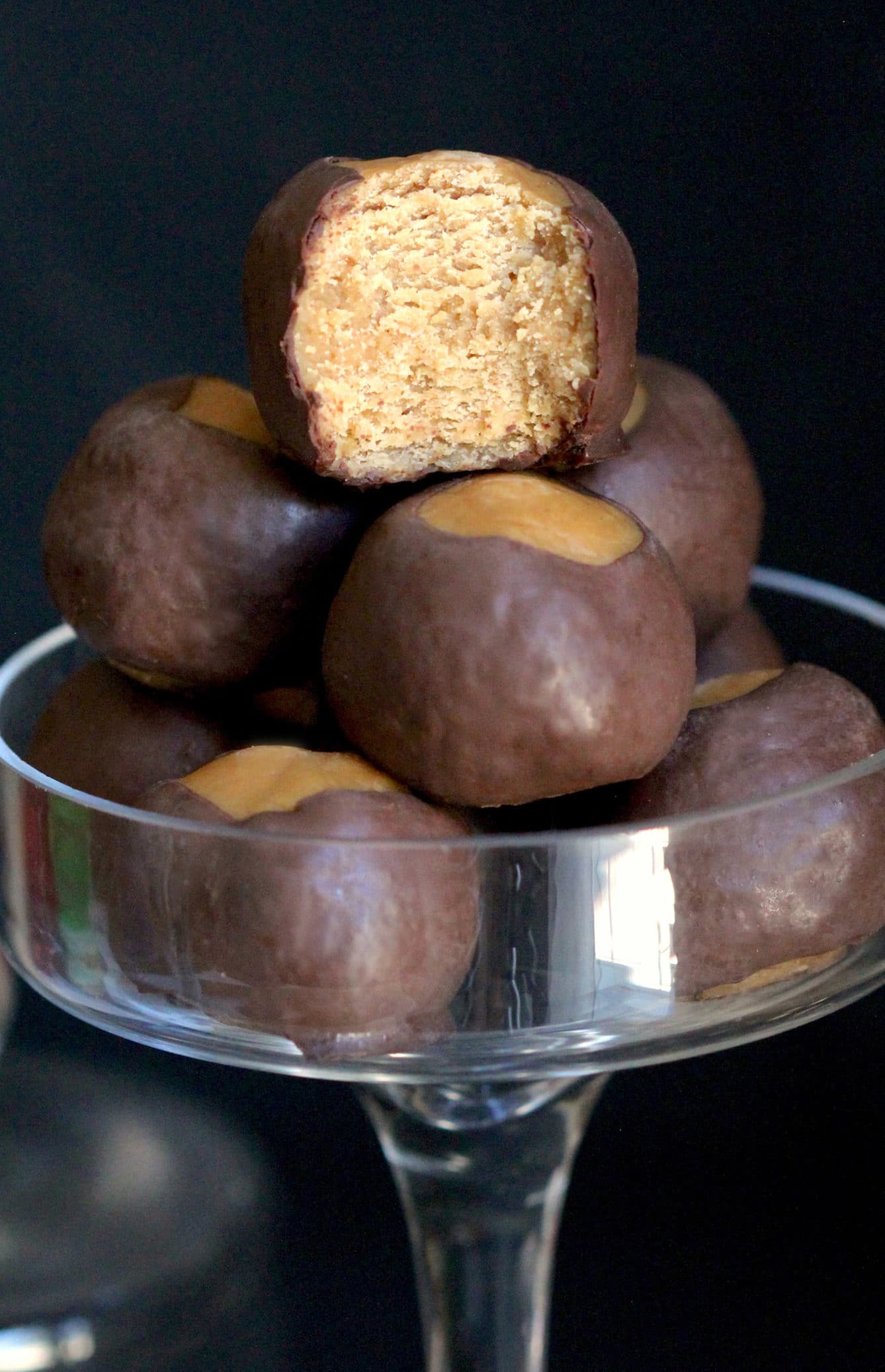 These Healthy Buckeye Balls are sweet and fudgy, peanut buttery orbs of magic surrounded by a layer of rich and decadent dark chocolate. It’s hard to believe they’re refined sugar free, low carb, high protein, and gluten free! Healthy Dessert Recipes at Desserts with Benefits