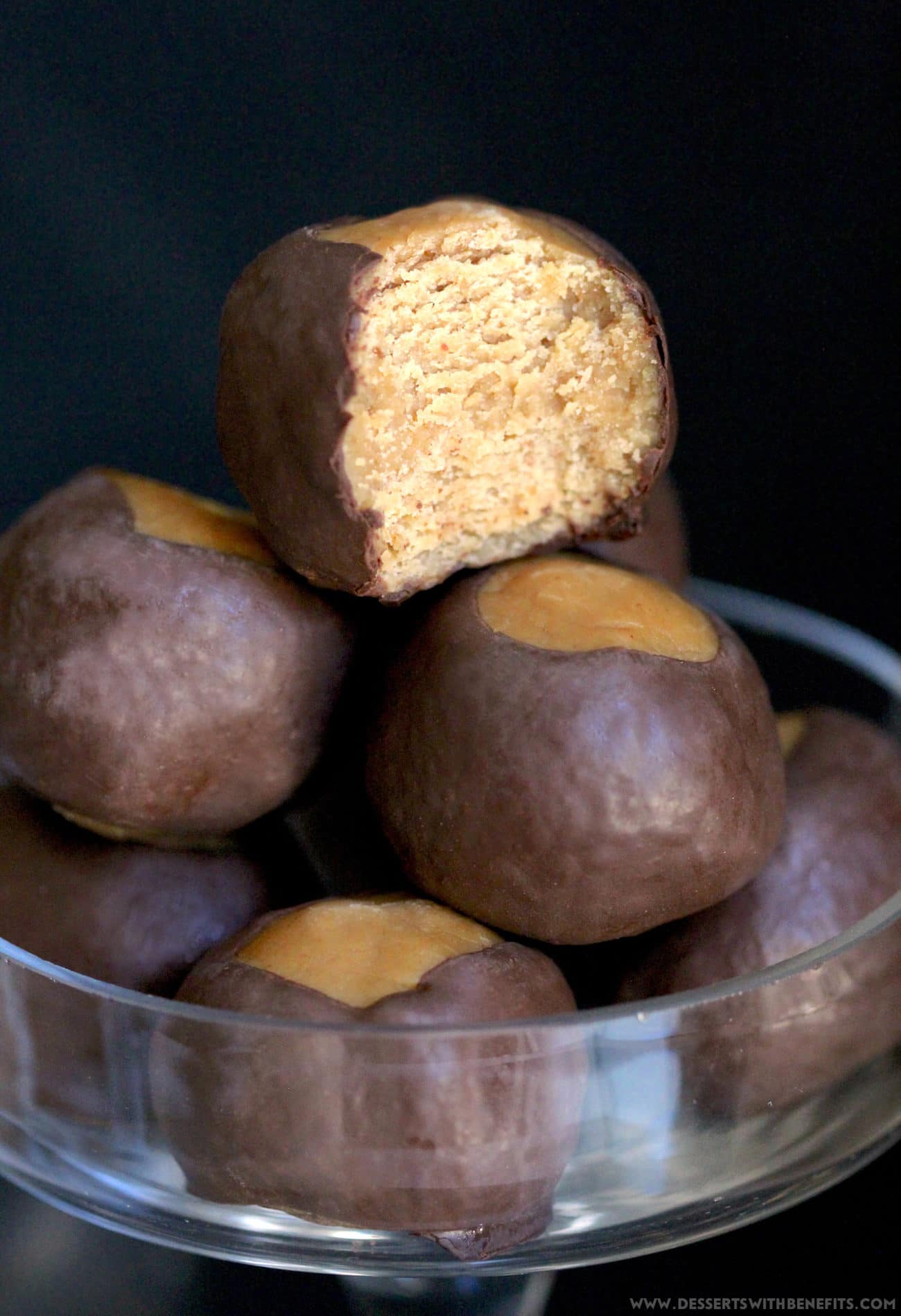 These Healthy Buckeye Balls are sweet and fudgy, peanut buttery orbs of magic surrounded by a layer of rich and decadent dark chocolate. It’s hard to believe they’re refined sugar free, low carb, high protein, and gluten free! Healthy Dessert Recipes at Desserts with Benefits