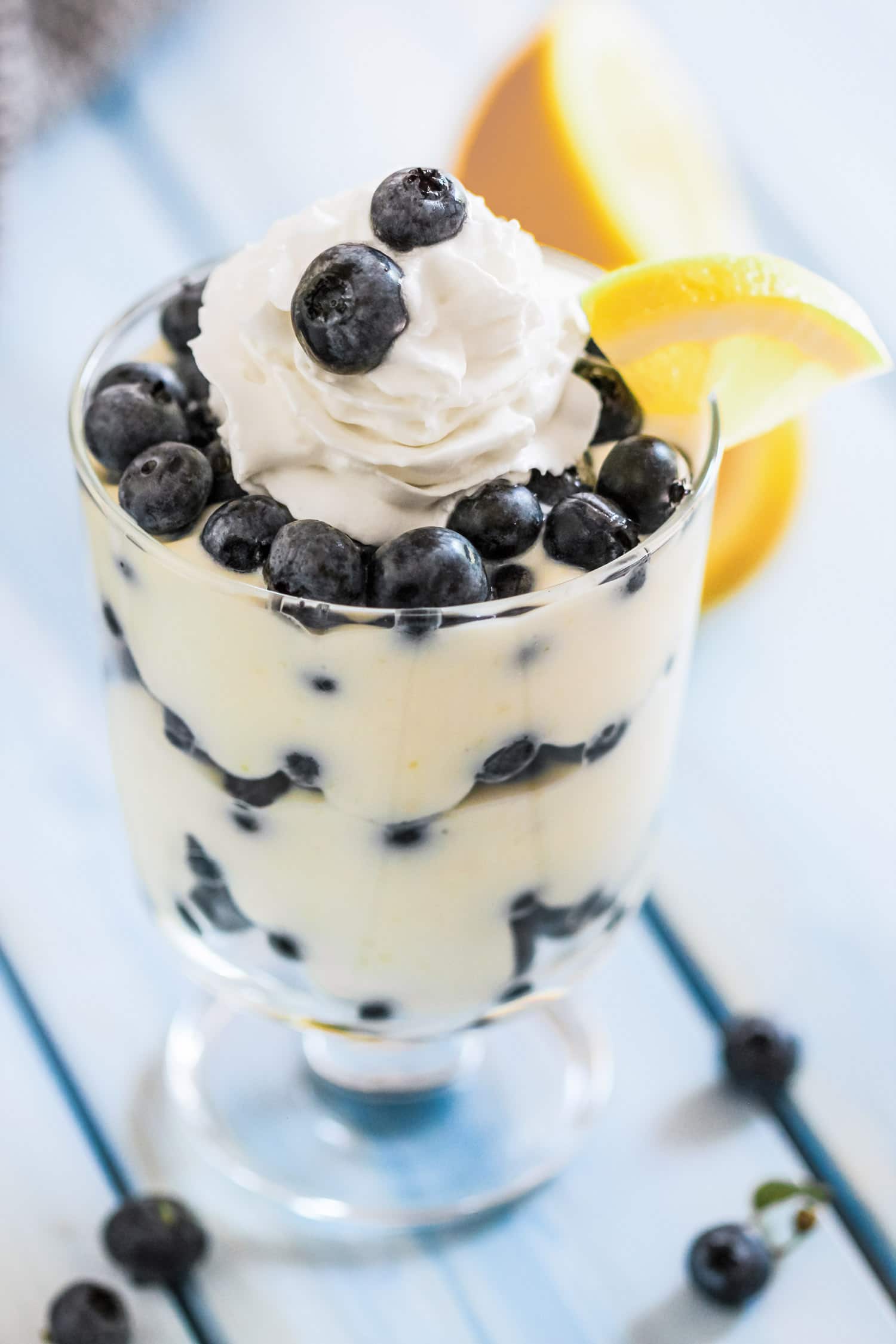 4-ingredient Blueberry Lemon Ricotta Parfaits! Beautiful, sophisticated, SO easy to make. The tart lemon balances the rich and creamy ricotta layers, and the blueberries complement both perfectly. Sugar free, low carb, high protein, and gluten free too! Healthy Dessert Recipes at the Desserts With Benefits Blog