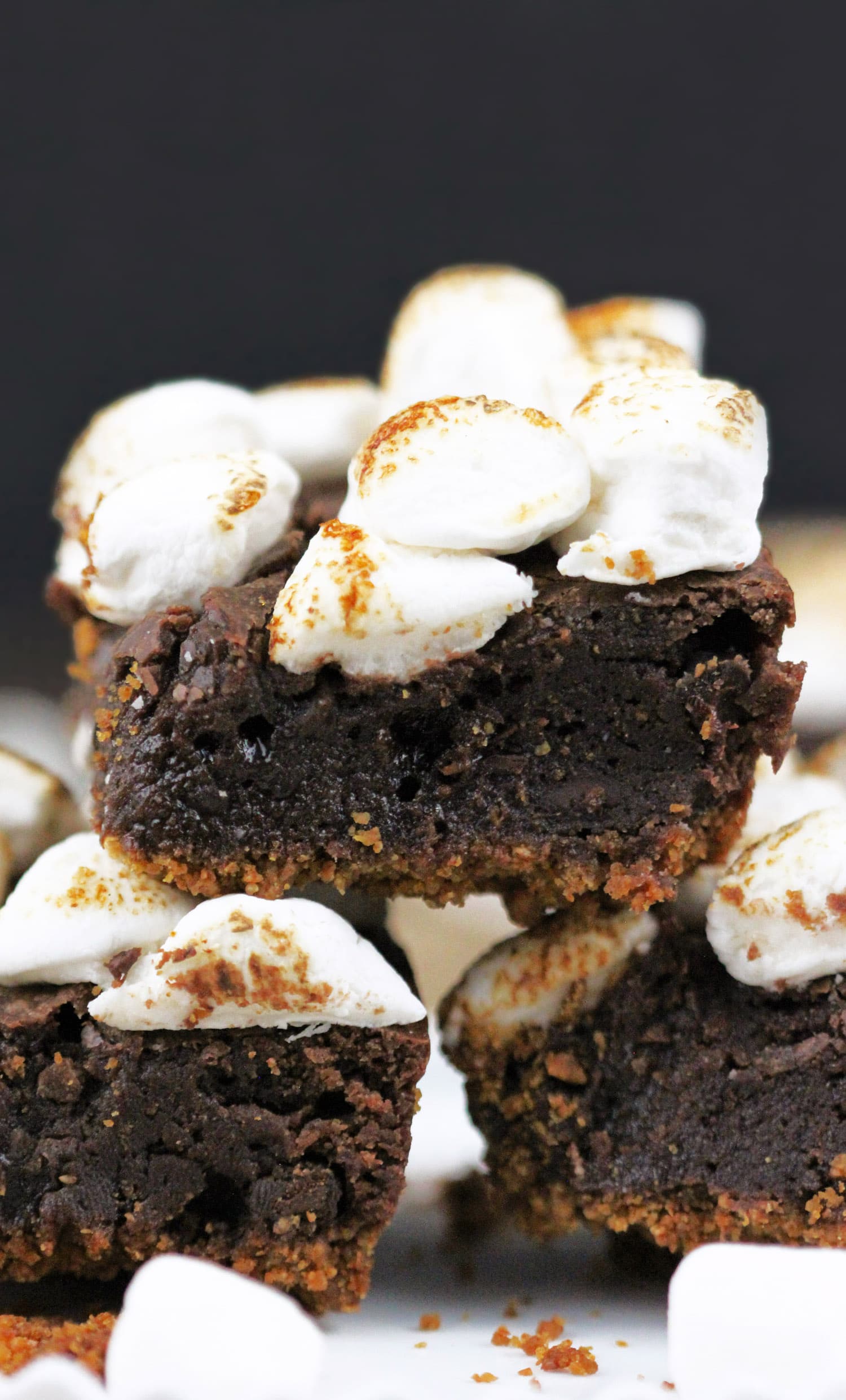 6-ingredient S’mores Brownies! Satisfy your s’mores craving with these delicious brownies. Made with an actual graham cracker crust, fudge brownie filling, and a sweet marshmallow studded topping, every bite is full of salty-sweet graham cracker flavor, decadent chocolate, and toasted mallows. Healthy Dessert Recipes at the Desserts With Benefits Blog (www.DessertsWithBenefits.com)