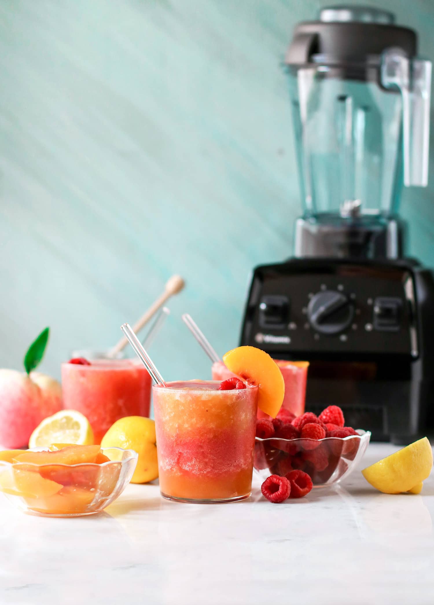 This Peach Melba Frosé is full of sweet peaches, tart raspberries, and good ol' pinot noir rosé (and no sugar added)! You only 5 ingredients to make this easy frose recipe. This is the perfect frosty, boozy treat!