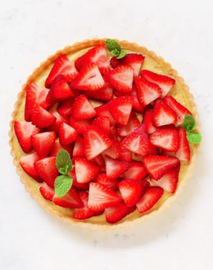 This beautiful Strawberry Tart has a rich and flavorful pie crust, the creamiest, vanilla bean-infused Pastry Cream, and is topped off with sweet, freshly sliced strawberries. It's hard to believe this delicious tart is dairy free and low sugar too!