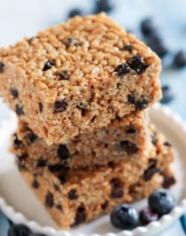 These Blueberry Bliss Krispy Treats are secretly healthy -- made with whole grain brown rice cereal, low glycemic raw honey, delicious almond butter, and a sprinkling of protein powder. It's crispy and chewy, but without the butter and sugary, high-fructose corn-syrup-laden marshmallows.