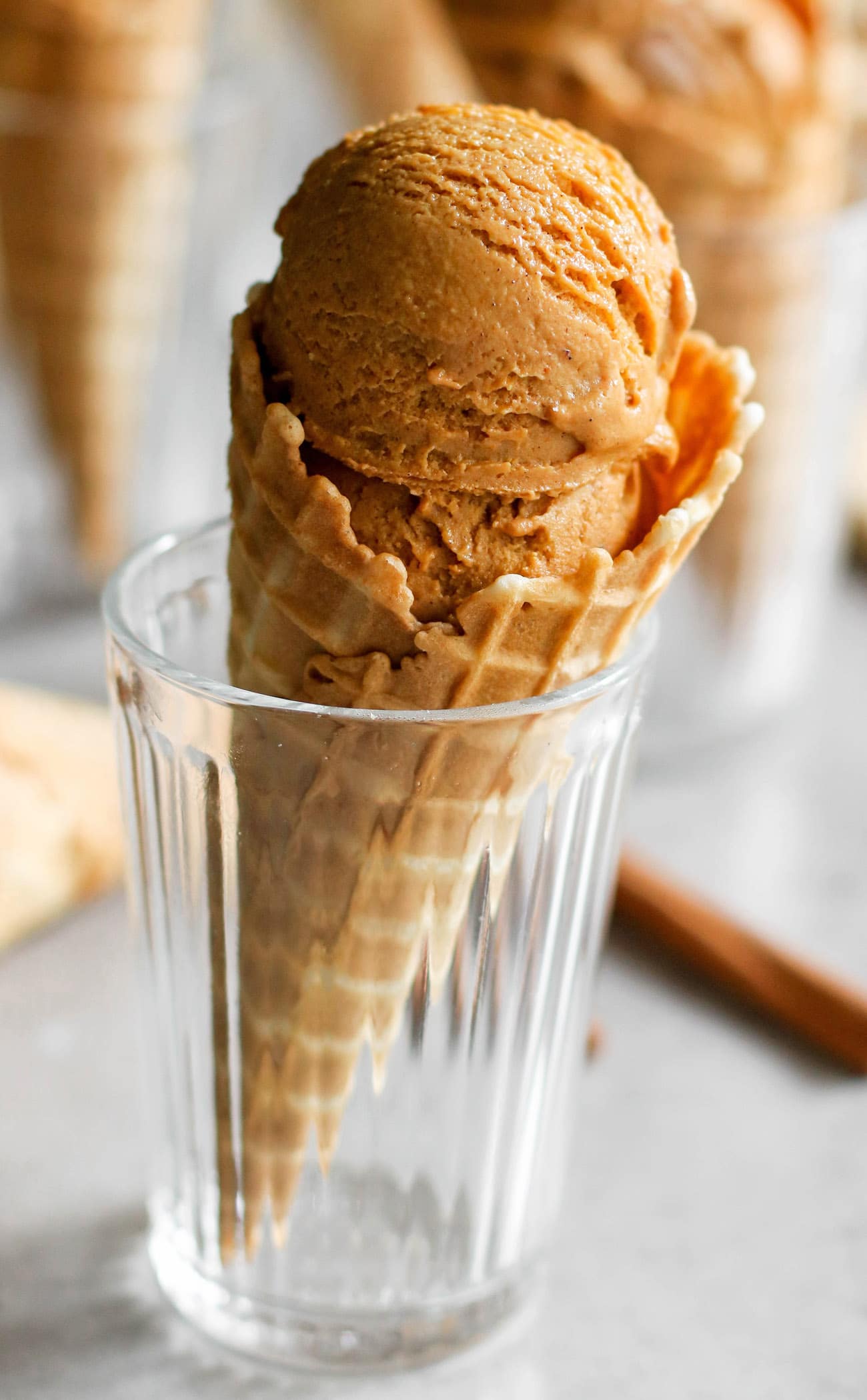 This Healthy Pumpkin Ice Cream is ULTRA creamy, perfectly spiced, and sweet enough to satisfy your sweet tooth. Best of all, it's made with 100% good-for-you ingredients! No heavy cream, no eggs, and no refined sugar! Instead, this version is low fat, refined sugar free, high protein, and gluten free too! #pumpkin #pumpkinpiespice #allnatural #refinedsugarfree #healthyicecream #highprotein #lowfat #easy #homemadeicecream