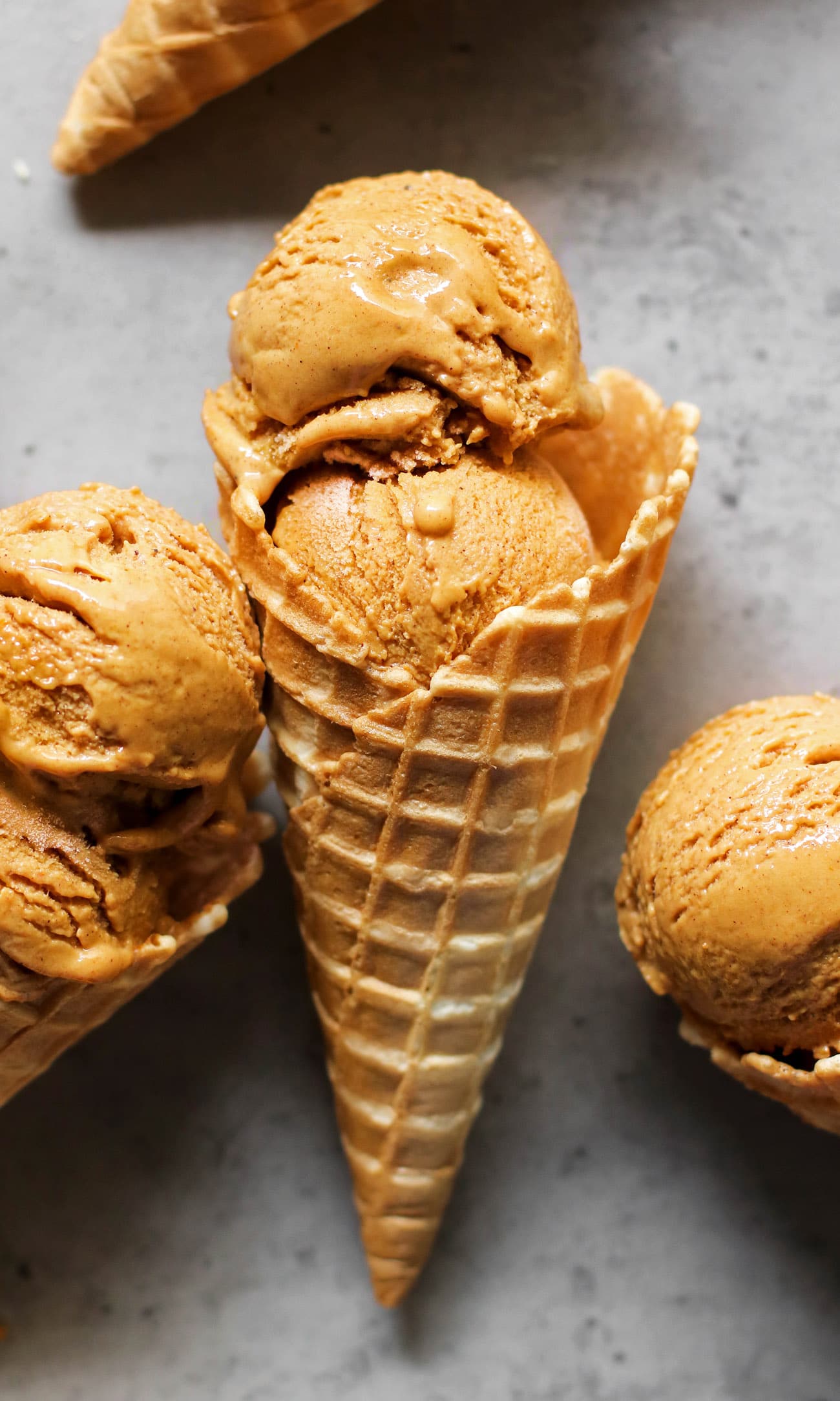 This Healthy Pumpkin Ice Cream is ULTRA creamy, perfectly spiced, and sweet enough to satisfy your sweet tooth. Best of all, it's made with 100% good-for-you ingredients! No heavy cream, no eggs, and no refined sugar! Instead, this version is low fat, refined sugar free, high protein, and gluten free too! #pumpkin #pumpkinpiespice #allnatural #refinedsugarfree #healthyicecream #highprotein #lowfat #easy #homemadeicecream