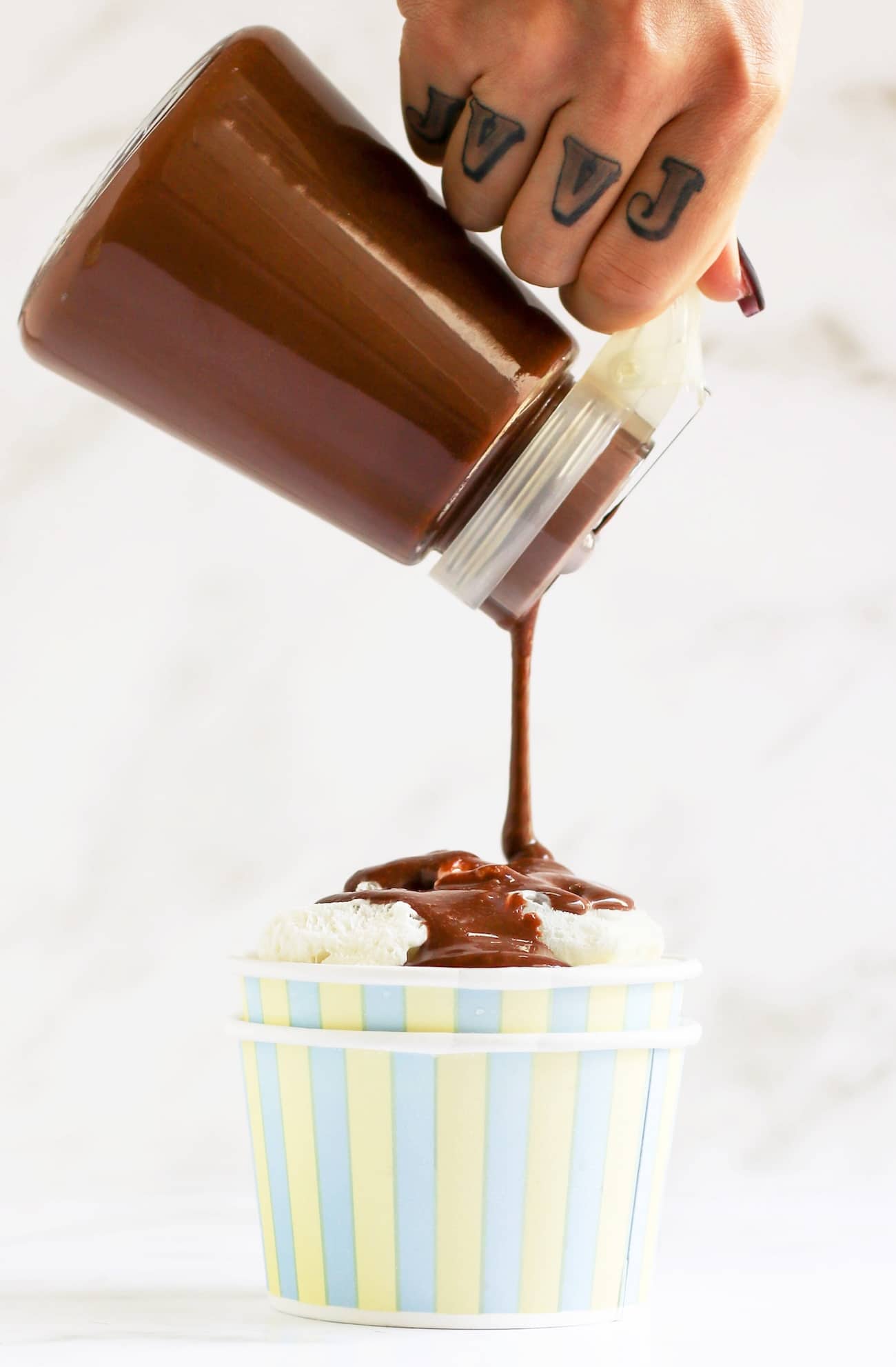 This Healthy Chocolate Fudge Sauce is rich, creamy, and delicious over ice cream, cake, and oatmeal, and mixed into milkshakes and trifles! Made with healthier ingredient swaps, this Hot Fudge Sauce is sugar free, low carb, low fat, and gluten free. Perfect as a potluck dessert topping, a homemade gift for birthdays and parties, and a pantry staple just for you.