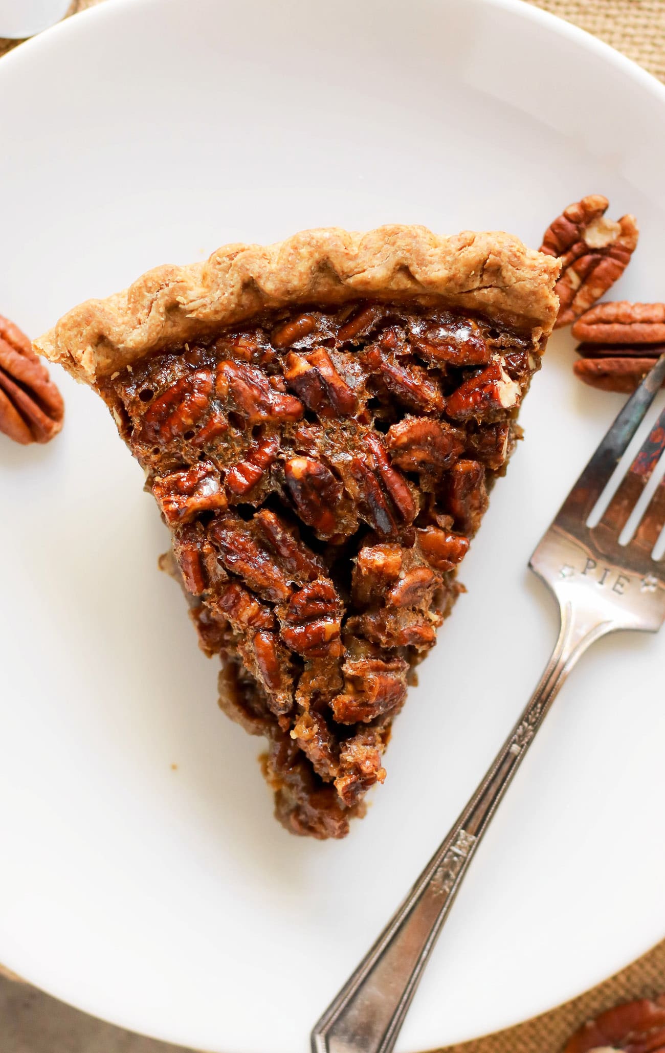 This Healthy Pecan Pie is so rich and decadent, every bite is pure joy -- you'd never know it's made without the corn syrup, white sugar, butter, and heavy cream! This freezer friendly Pecan Pie is an all natural, good-for-you dessert that is perfect for Thanksgiving, Christmas, birthdays, or any day for that matter!
